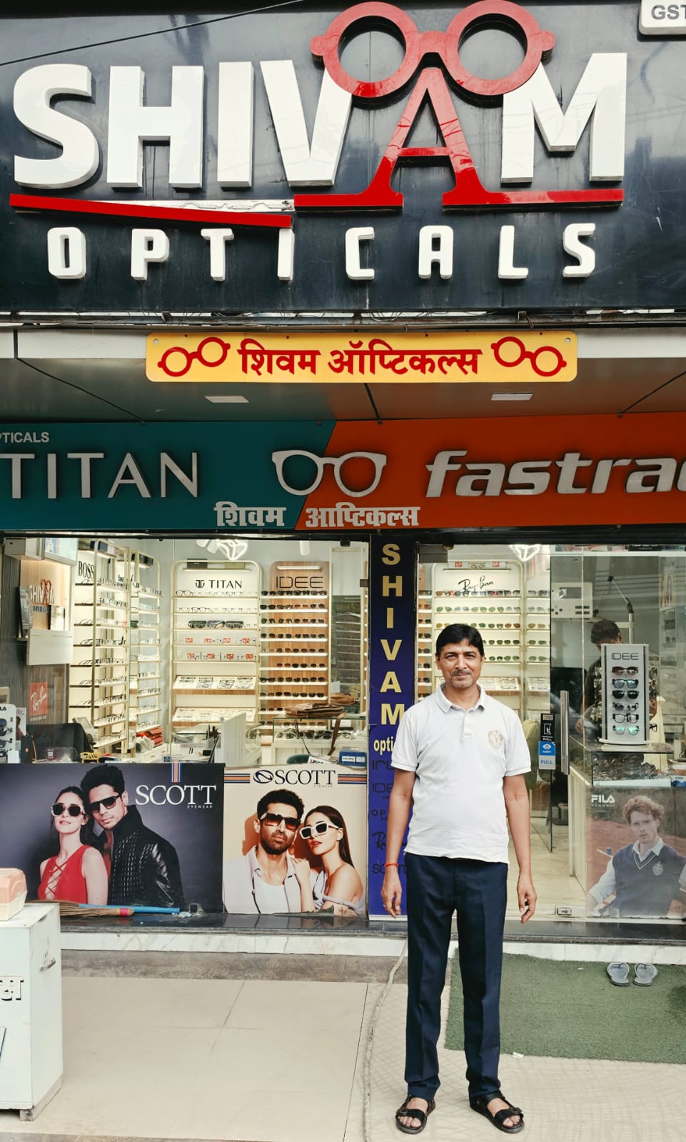 Arvind Dwivedi, Founder of Shivam Opticals, outside the Sultanpur showroom